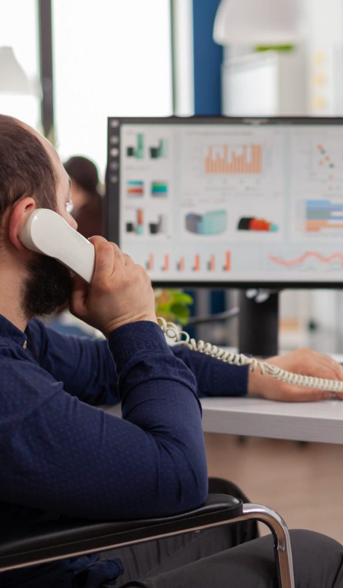 busy-disabled-team-leader-answering-phone-talking-with-partner-typing-computer-explaning-project-idea-checking-financial-data busy-disabled-team-leader-answering-phone-talking-with-partner-typing-computer-explaning-project-idea-checking-financial-data