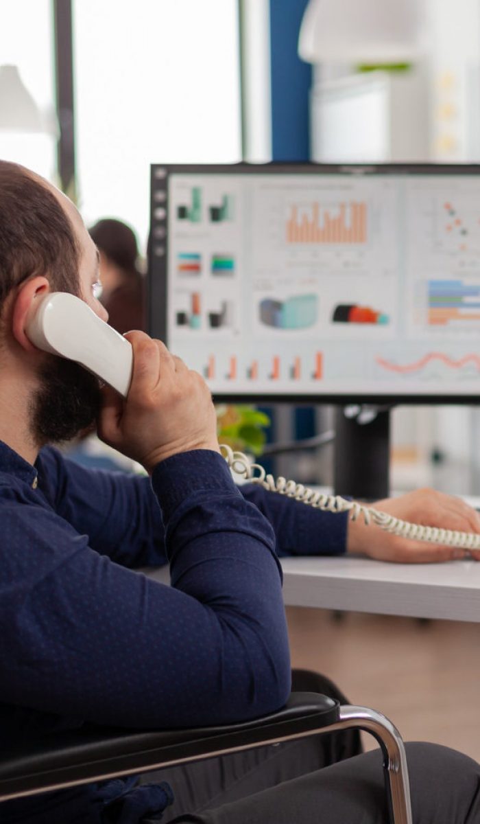 busy-disabled-team-leader-answering-phone-talking-with-partner-typing-computer-explaning-project-idea-checking-financial-data busy-disabled-team-leader-answering-phone-talking-with-partner-typing-computer-explaning-project-idea-checking-financial-data